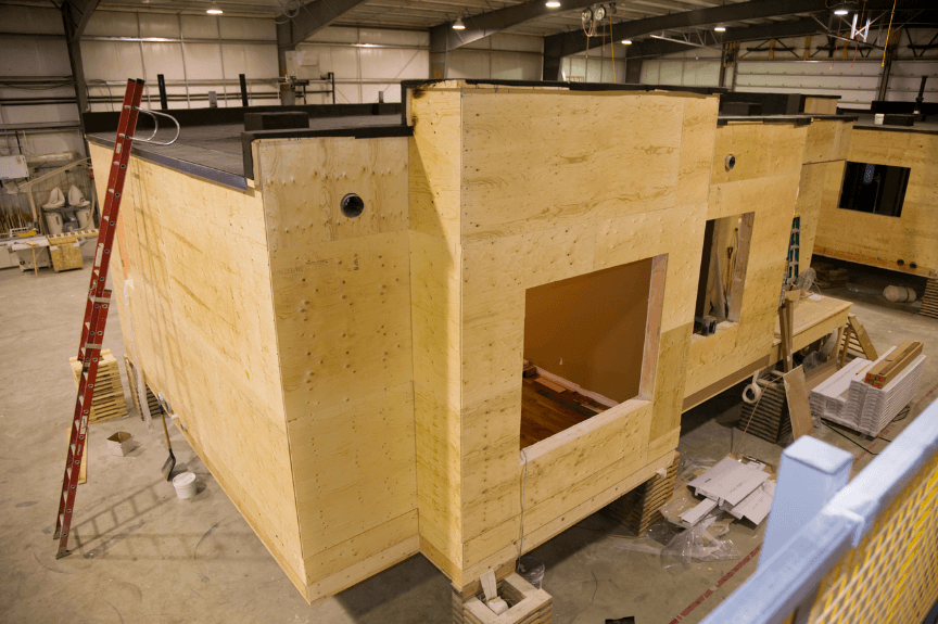 Modular home construction inside an air-conditioned facility.